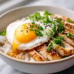 Delicious Gordon Ramsay chicken donburi served with vibrant toppings.